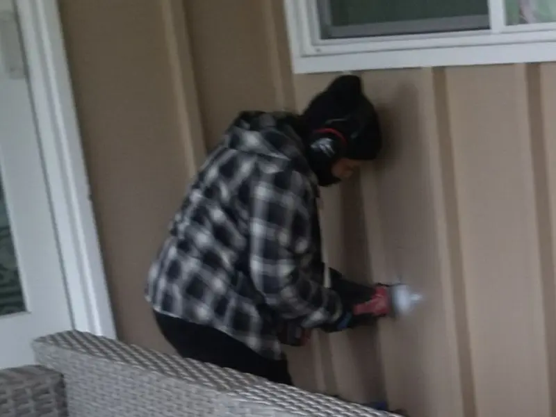 Professional electrician installing an exterior outlet in Fairview